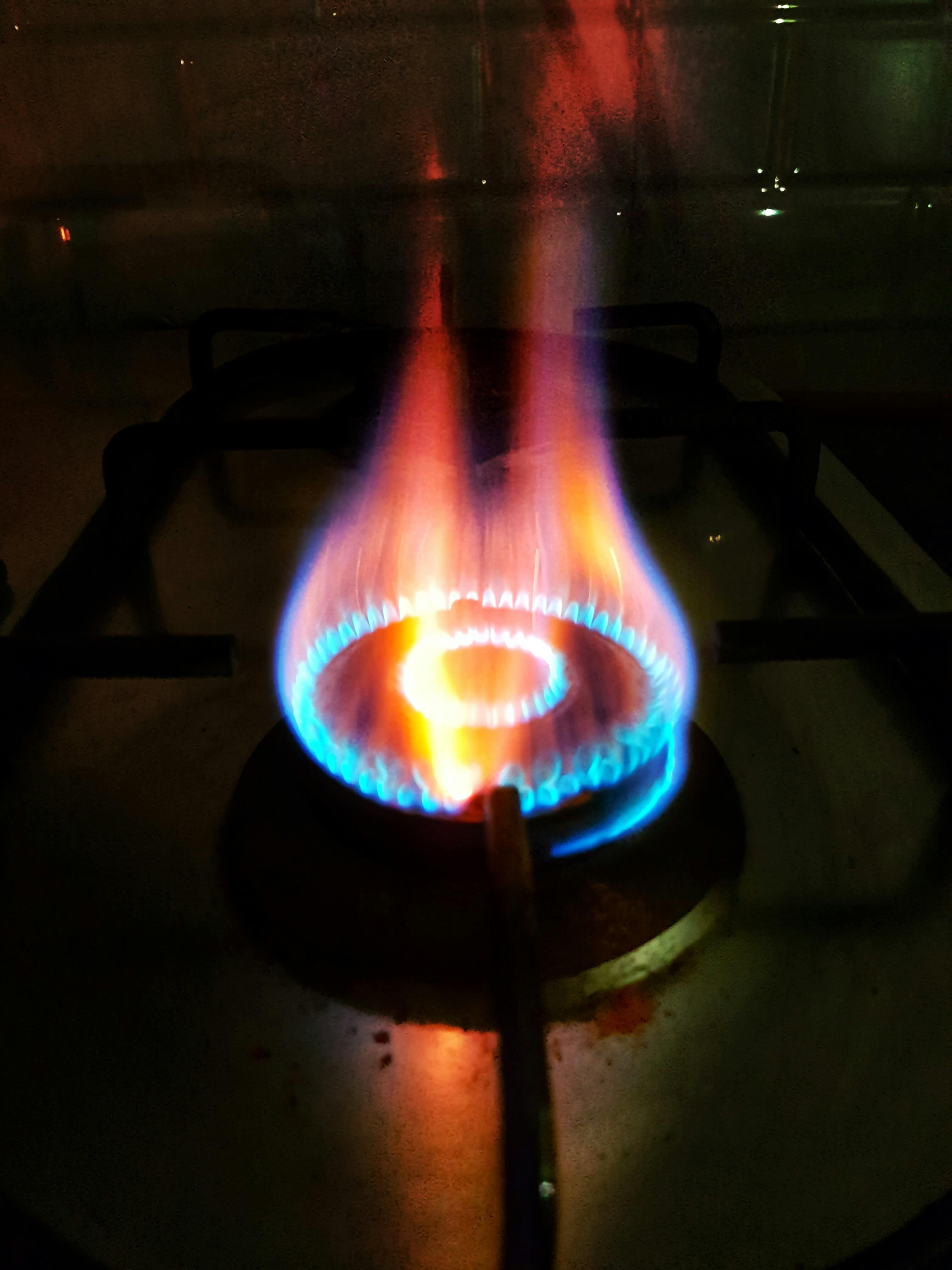 A stove heating a pot of water