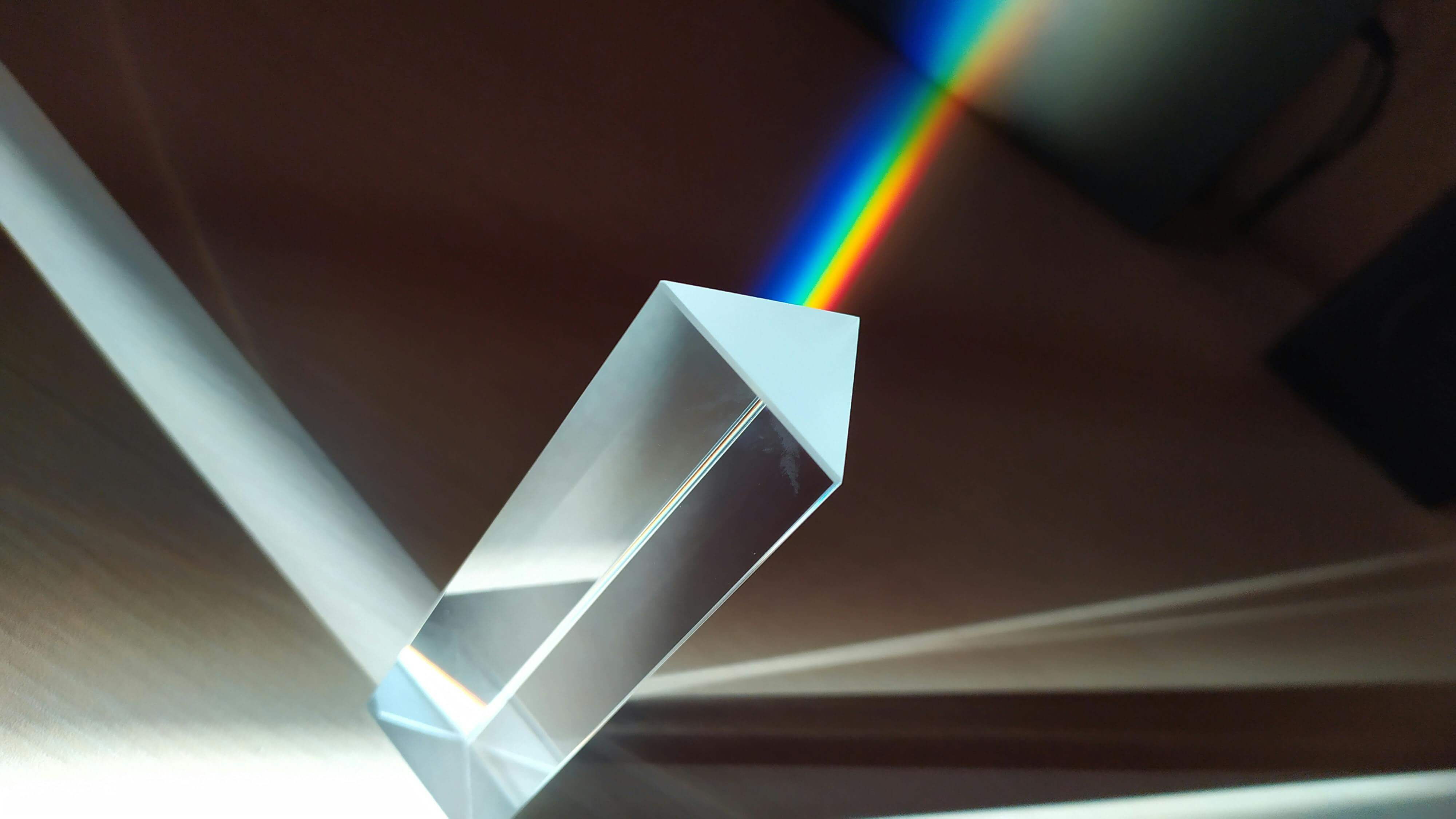 Glass block refracting light into a colorful rainbow